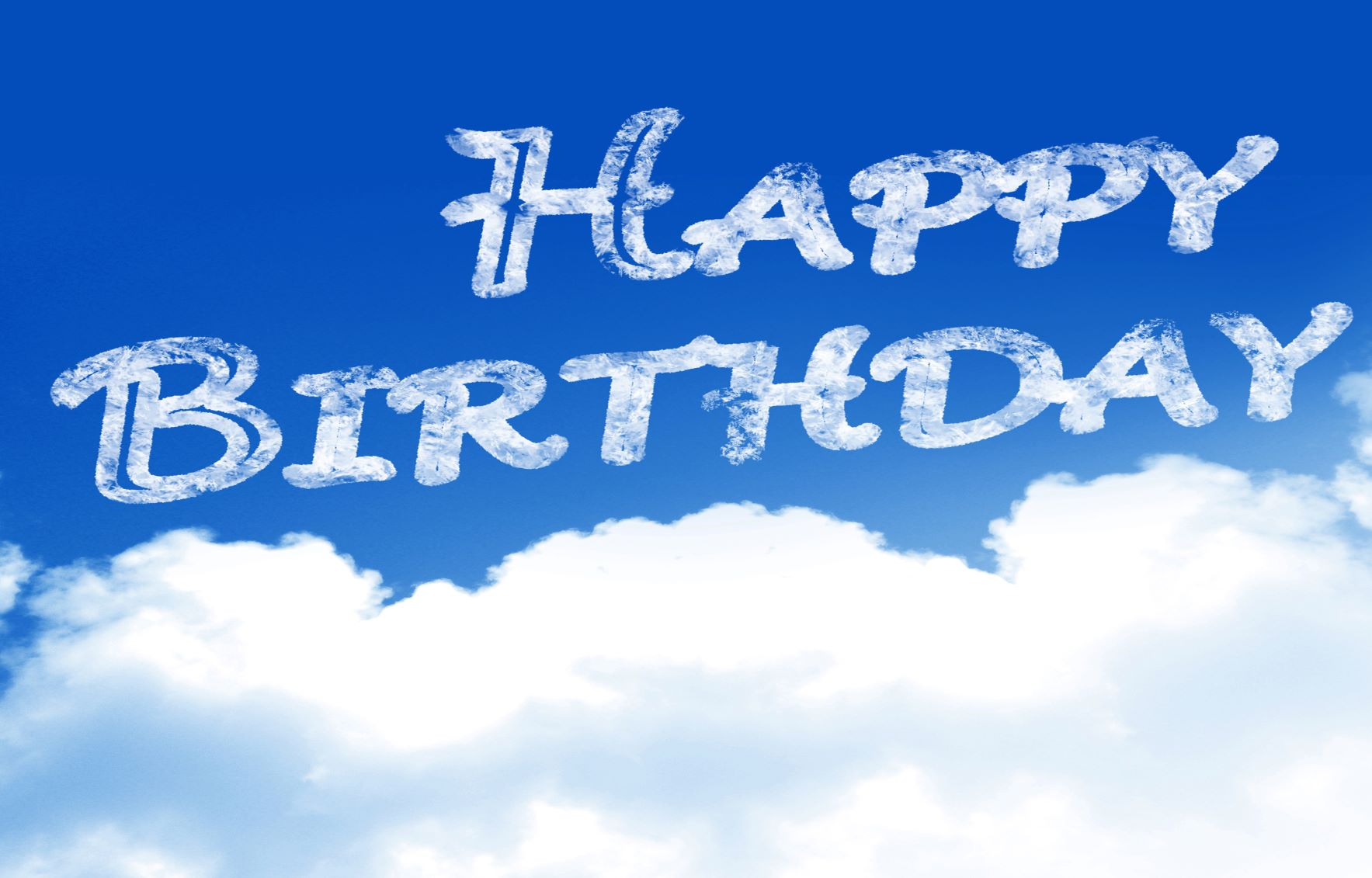 Happy birthday written with clouds in the sky